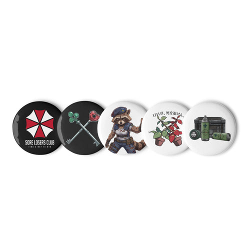 Set of five 1.25 inch pin buttons showing the biotech "Find a Way to Win" SLC logo, the tactical raccoon, survival horror keys, red and green herbs, and a safe room crate with first aid spray.