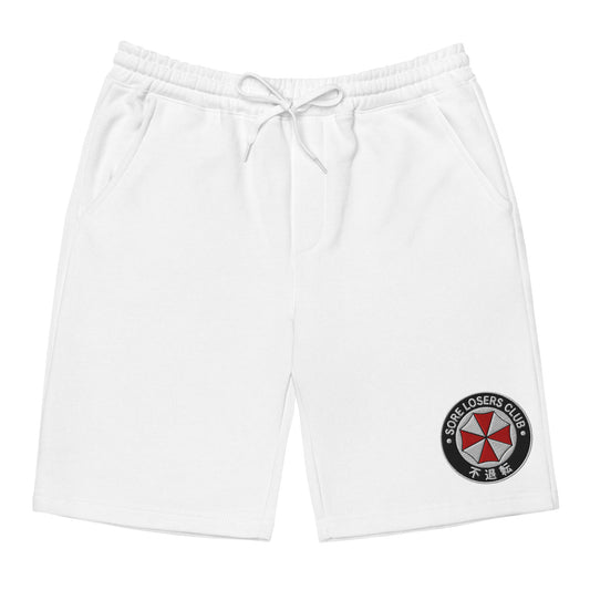 White fleece shorts, front view, with an embroidered Sore Losers Club biotech circle logo on the left leg.
