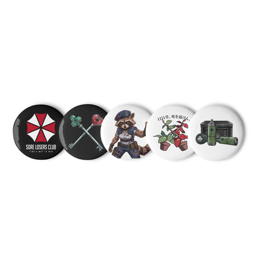 Set of five 1.25 inch pin buttons showing the biotech "Find a Way to Win" SLC logo, the tactical raccoon, survival horror keys, red and green herbs, and a safe room crate with first aid spray.