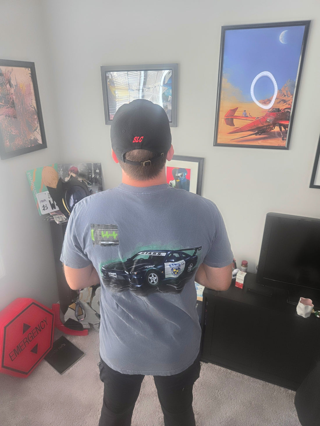 Back of the S15 First Aid Spray Survival Horror Tee in size L on a 5'10" model: the healed S15 and the FINE heart monitor